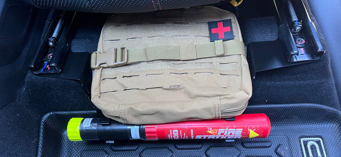 First aid pouch and Fire Stryker mounted to a front seat accessory bracket in a BYD Shark 6.